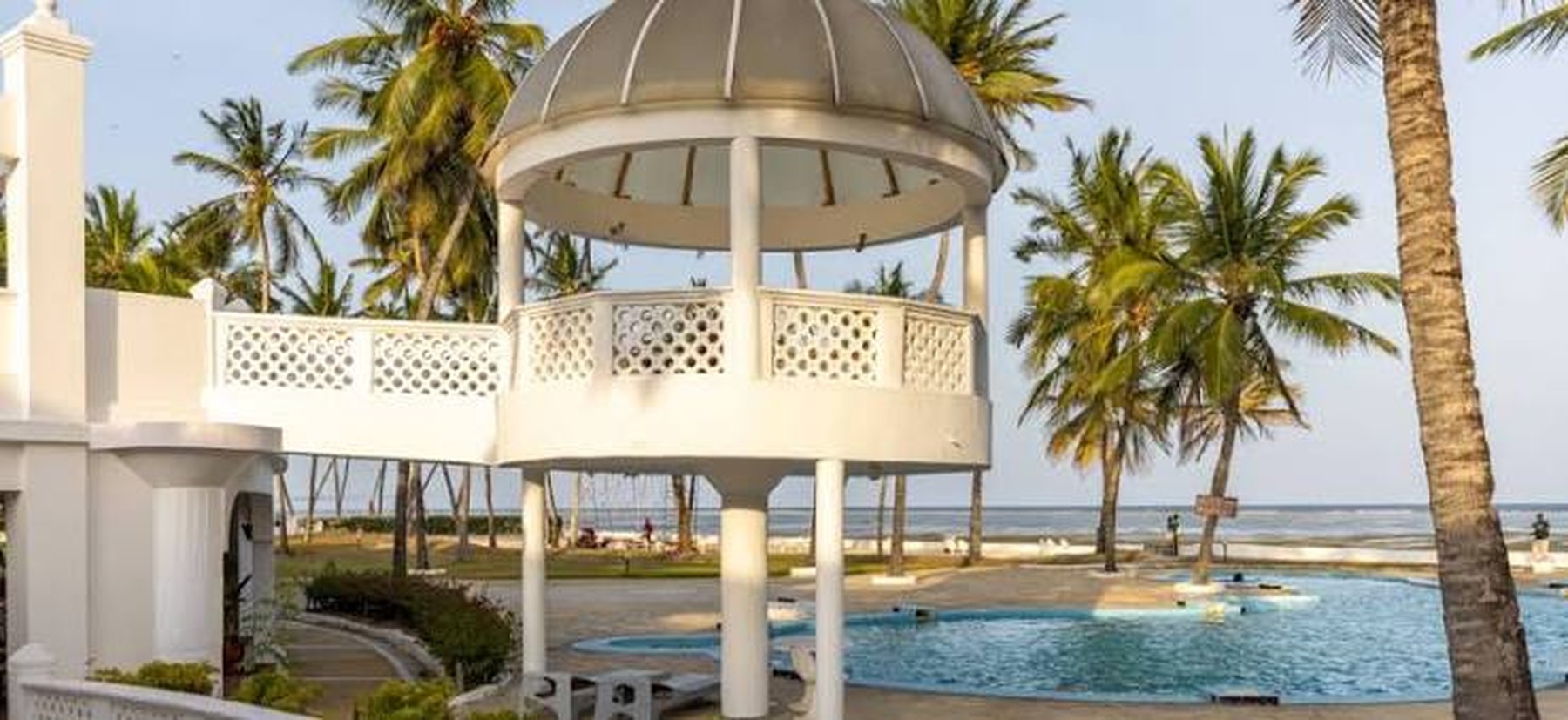 Poolside gazebo with palm trees at a Mombasa coast resort