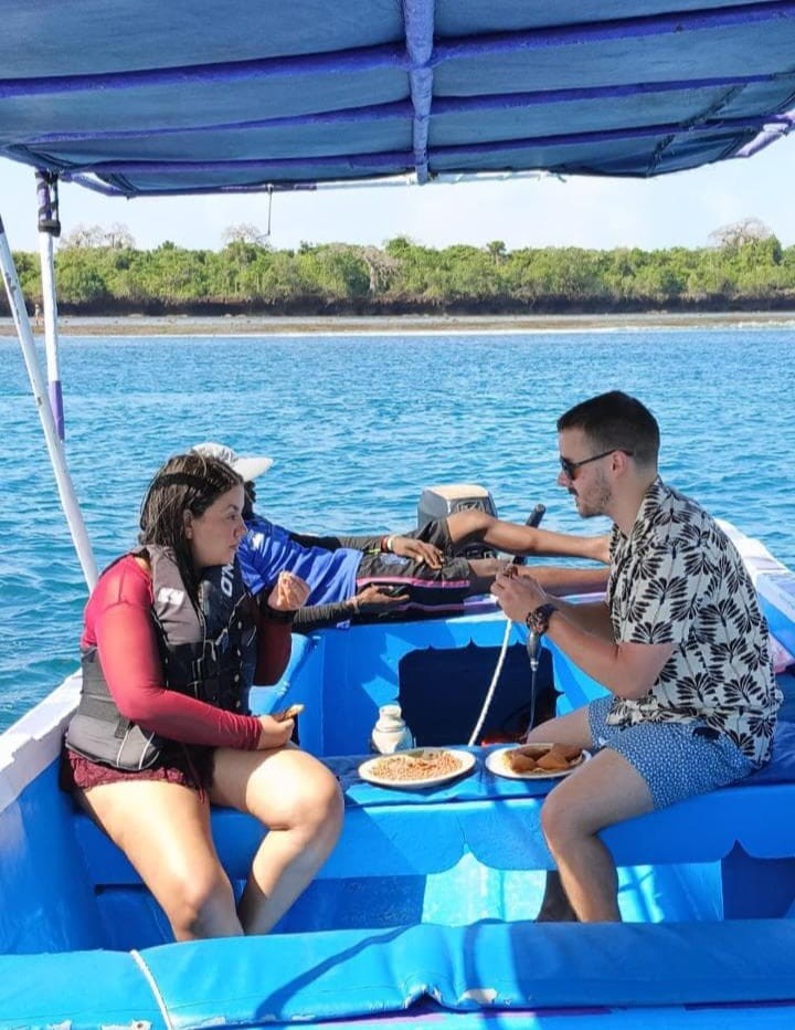 Guests sharing lunch aboard the boat off the Mombasa coast