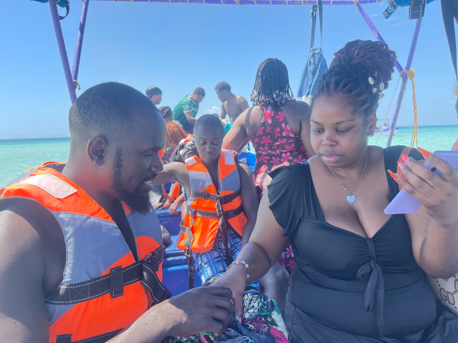 Guests in life jackets sharing a moment aboard the boat