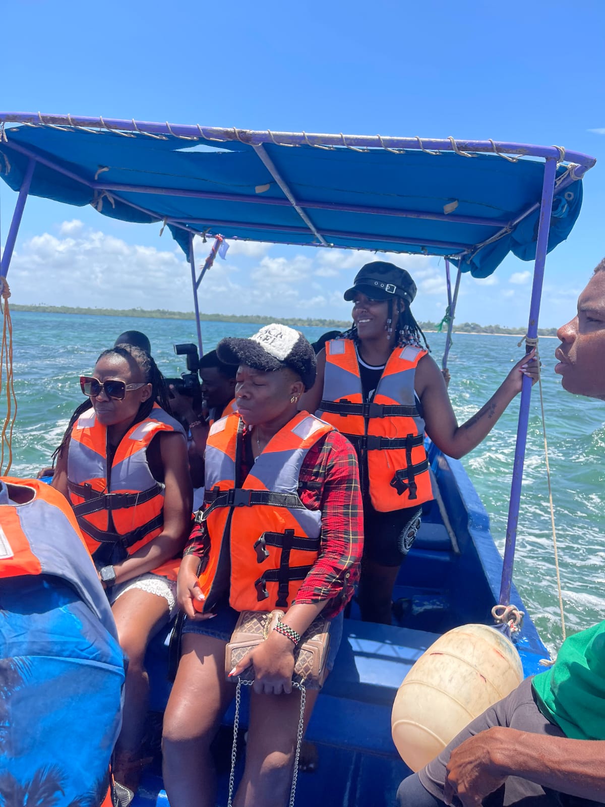 Three guests in life jackets aboard the boat