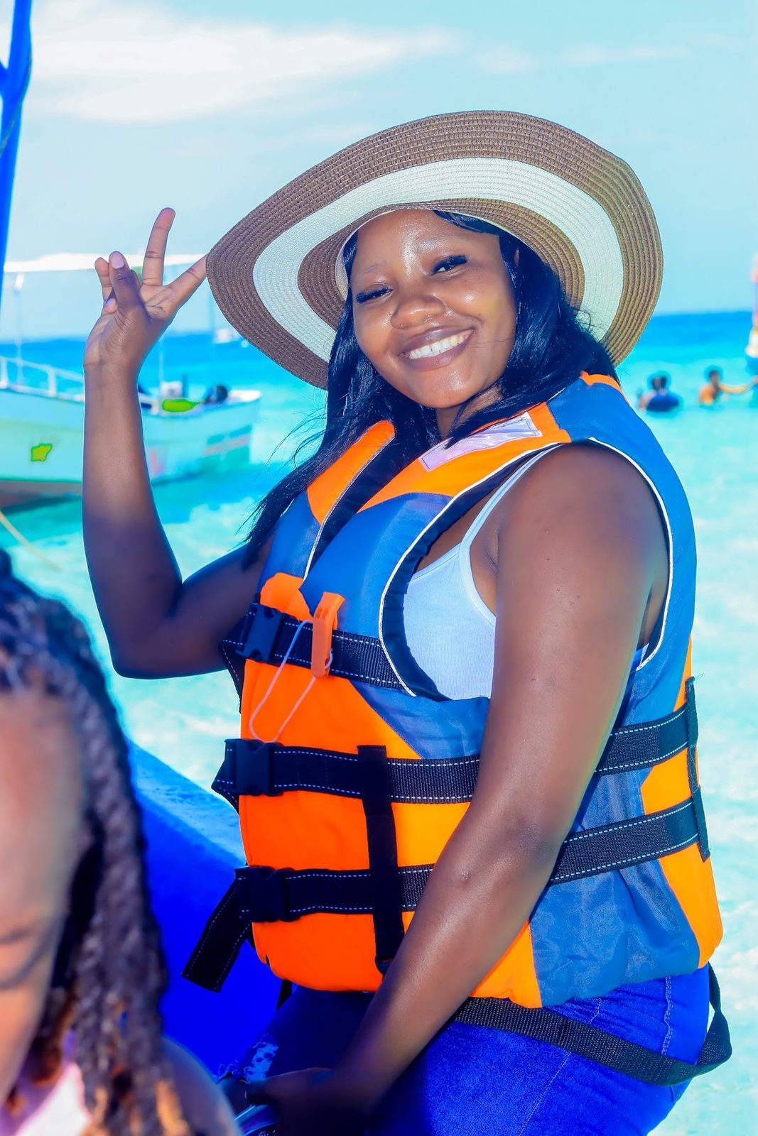 Guest in a sun hat and life jacket