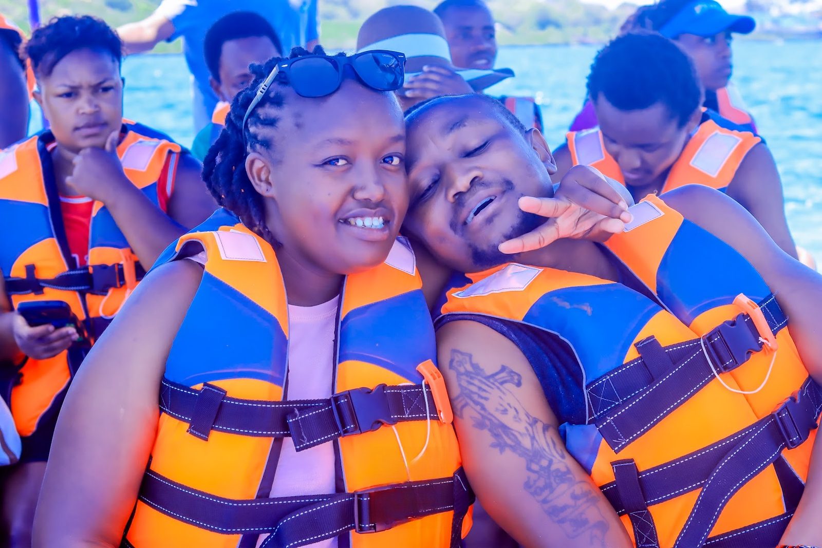 Friends in life jackets on the boat trip