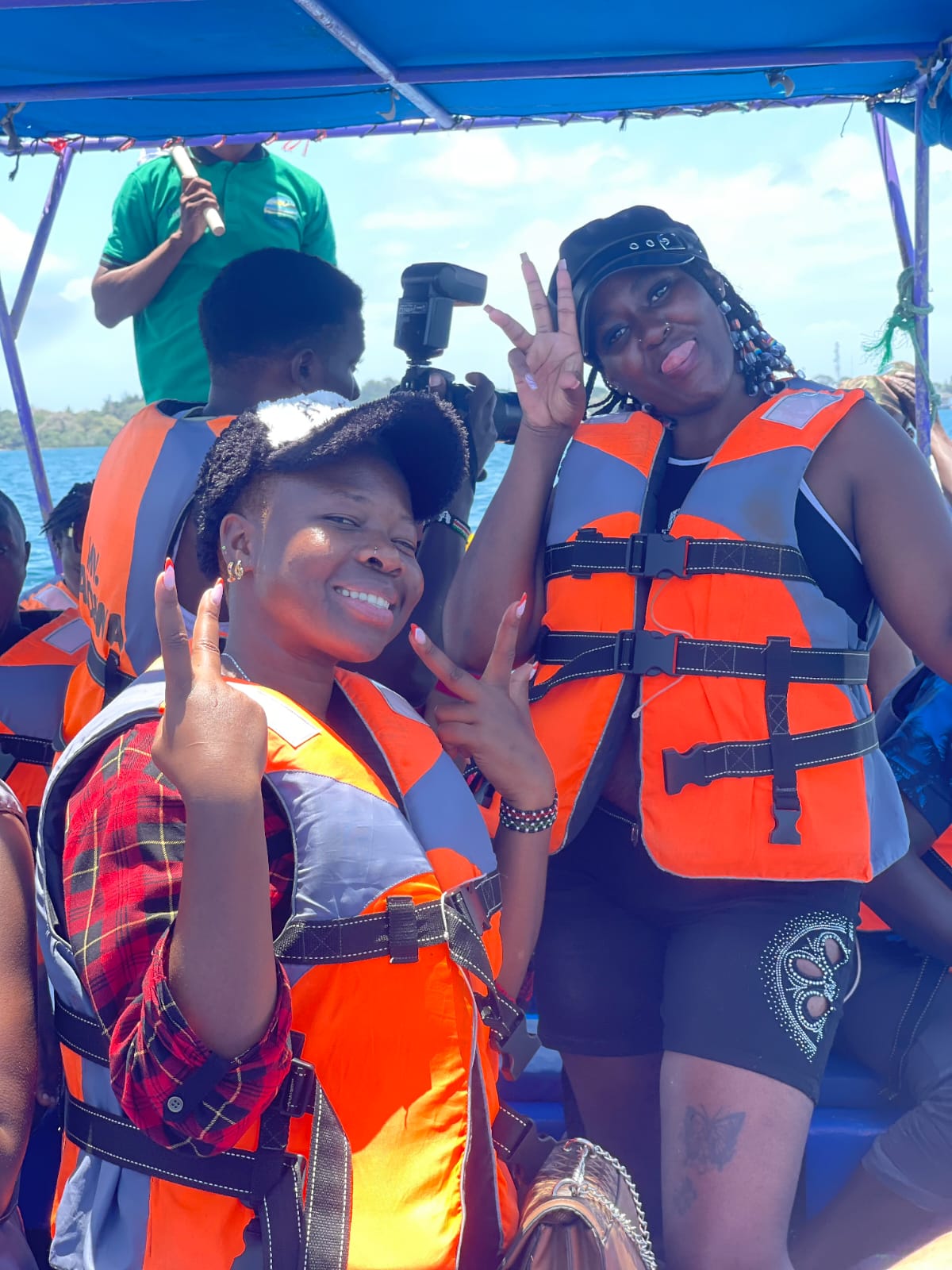 Two guests flashing peace signs aboard the boat