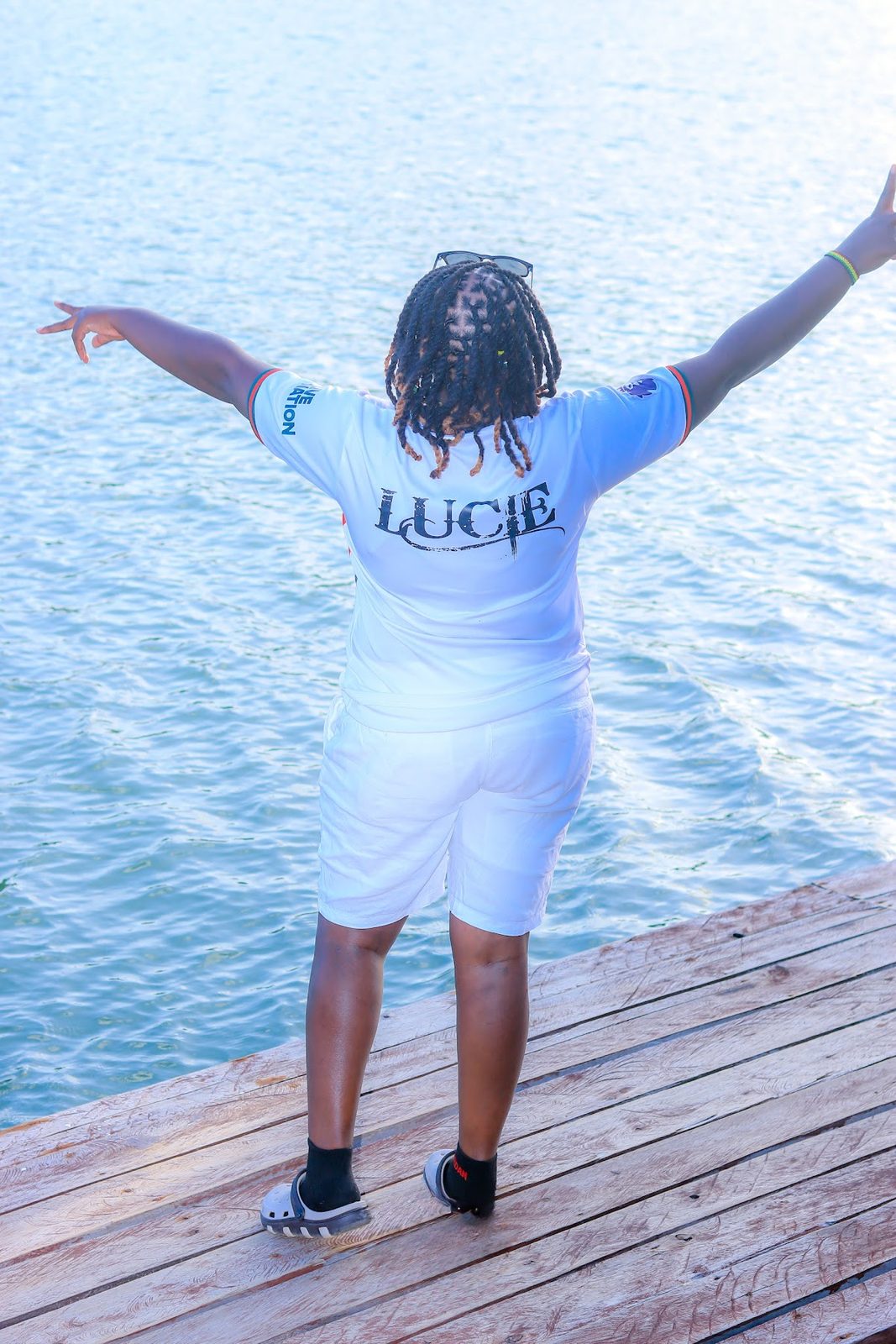 Guest with arms wide open over the creek