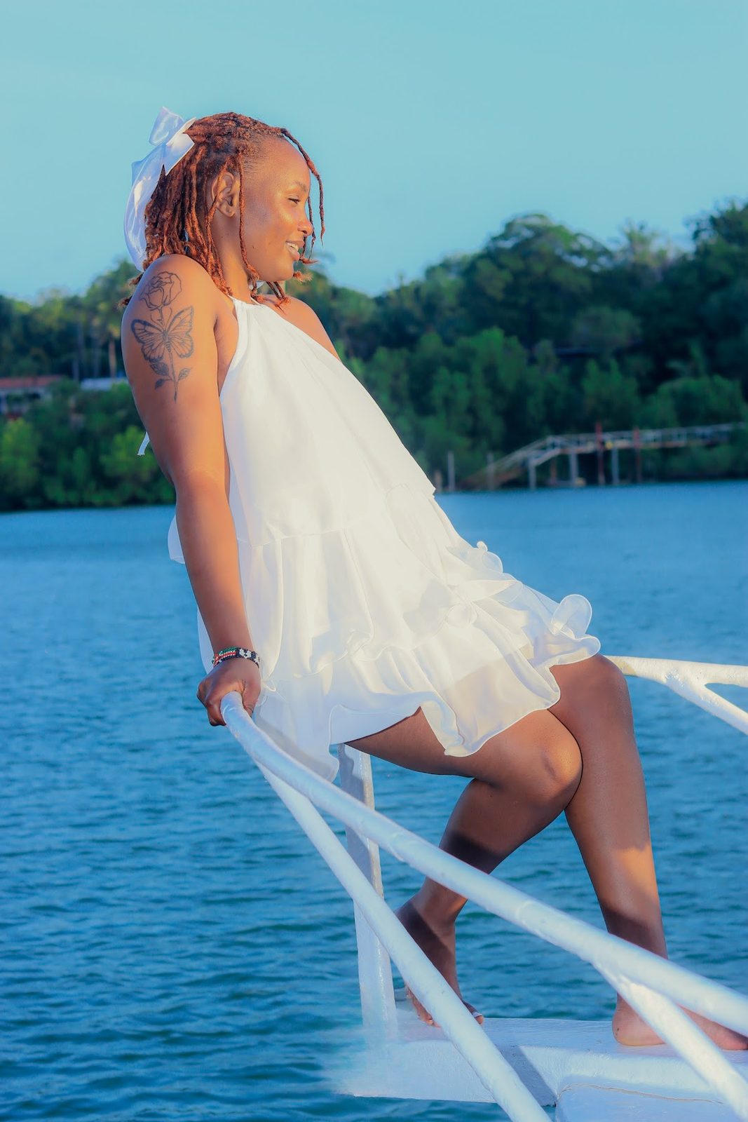 Guest's white dress catching the creek breeze