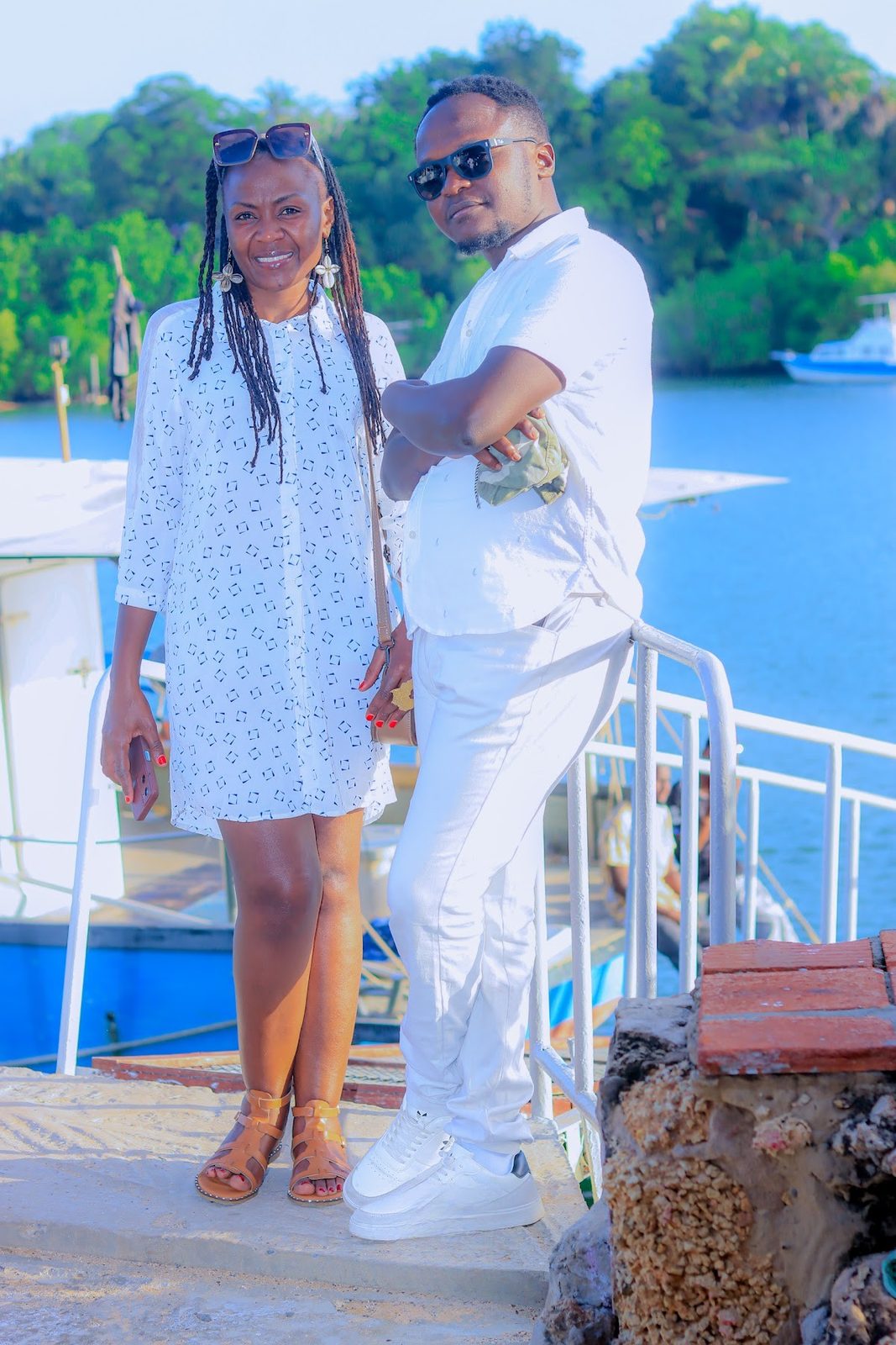 Two guests in white aboard the creek cruise