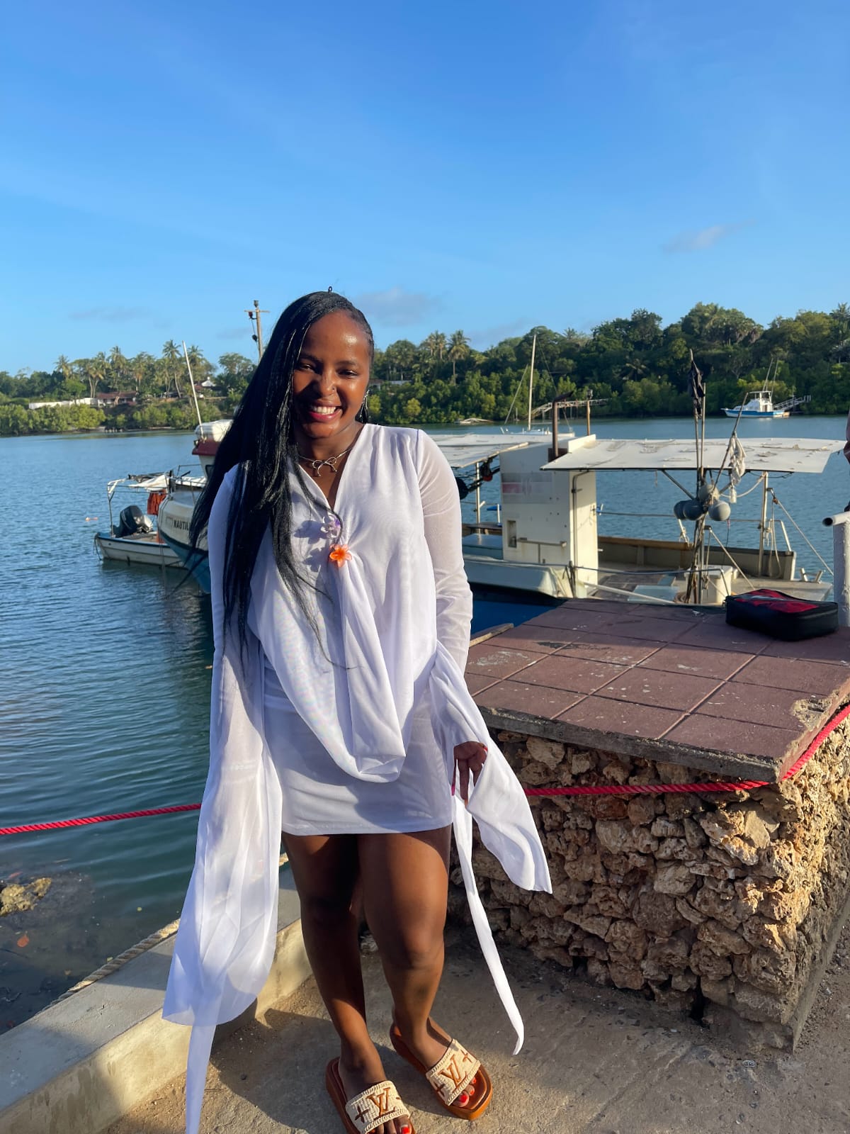 Guest in white at the creek dock before boarding