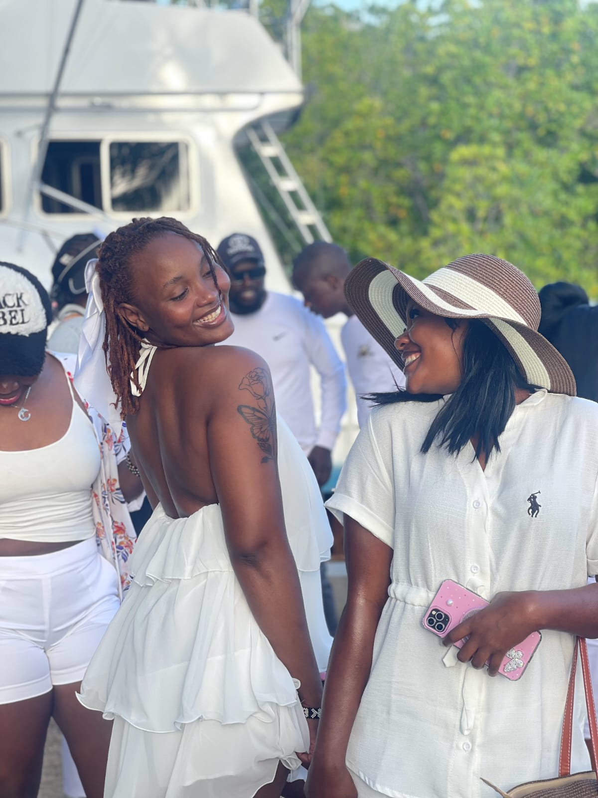 Two guests sharing a laugh at the creek gathering
