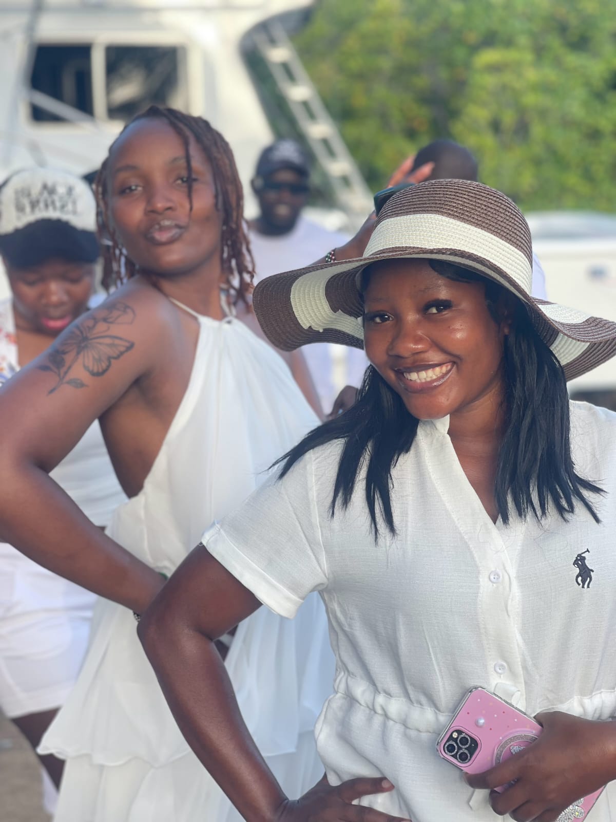 Two guests smiling together at the creek gathering