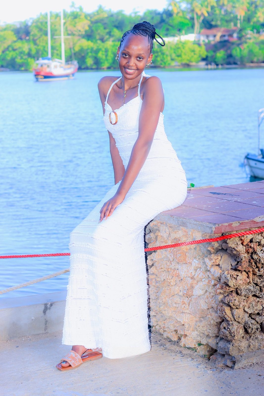 Guest in a white gown posing on the seawall