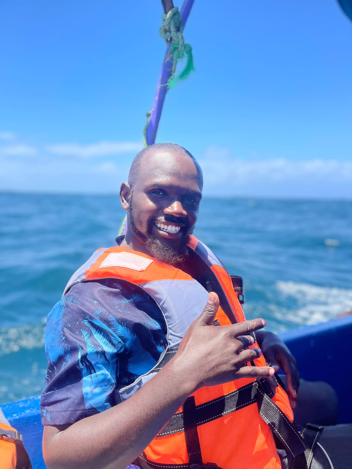 Smiling guide in a life jacket aboard the boat
