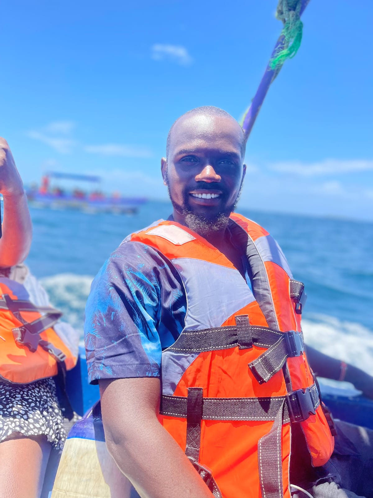 Guide in a life jacket smiling on the boat