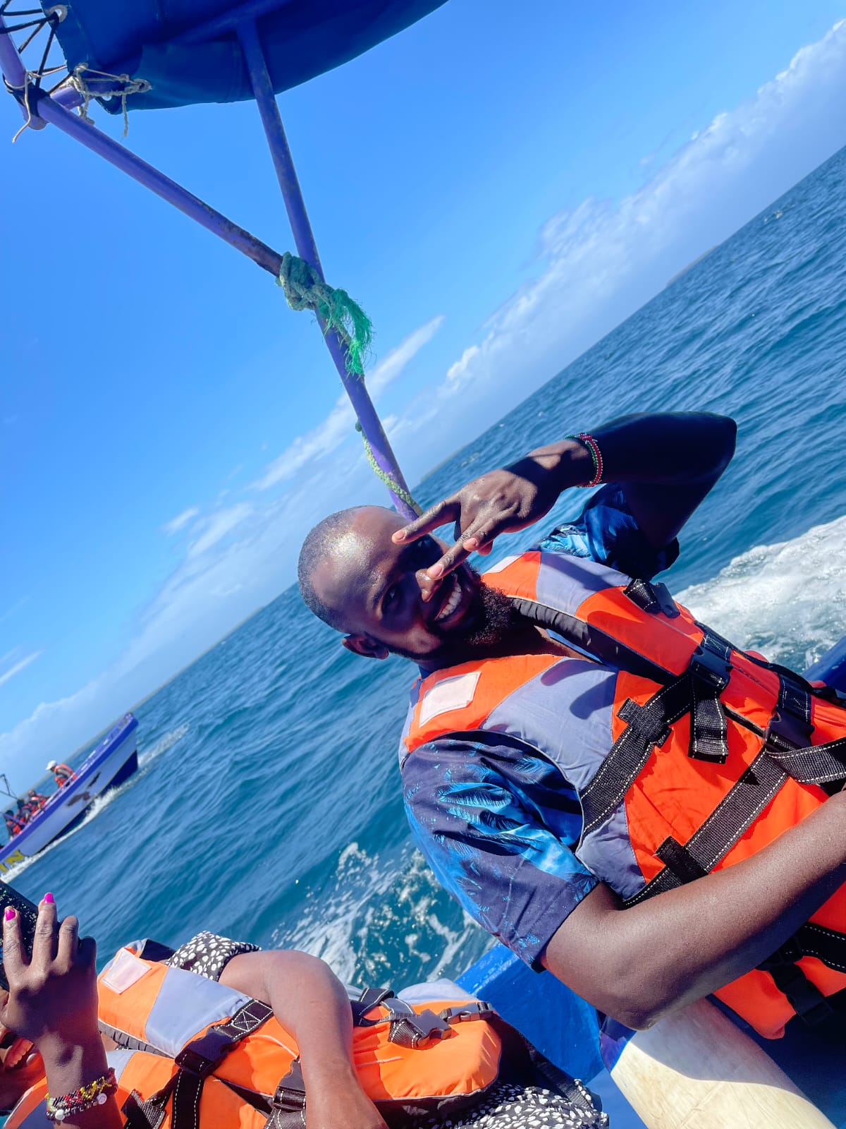 Guide flashing a peace sign aboard the boat
