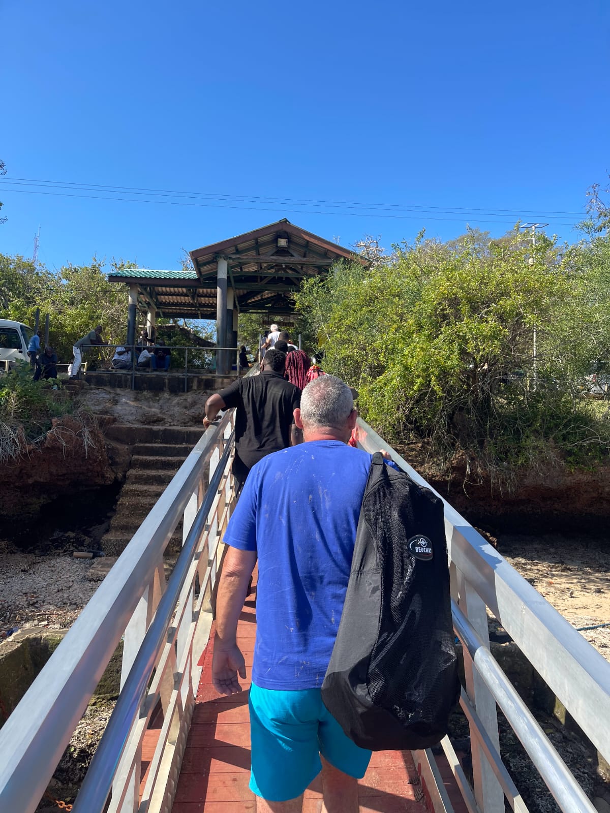 Guests walking along a jetty on a Mombasa boat excursion