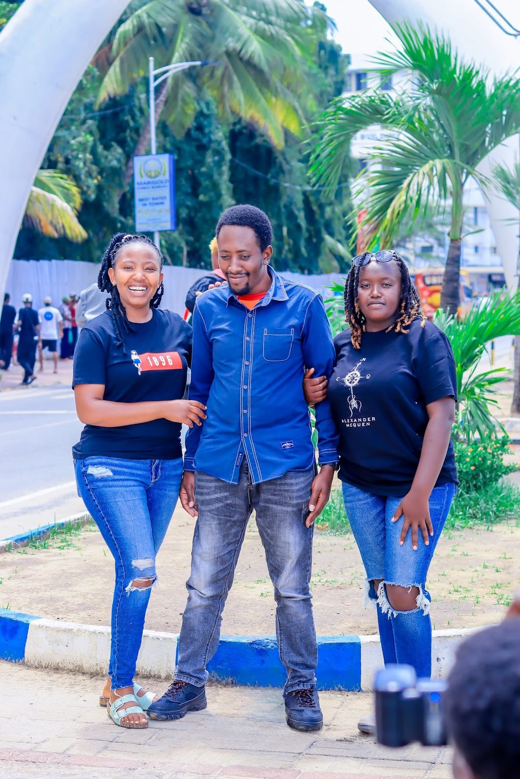 Three friends walking together on Moi Avenue