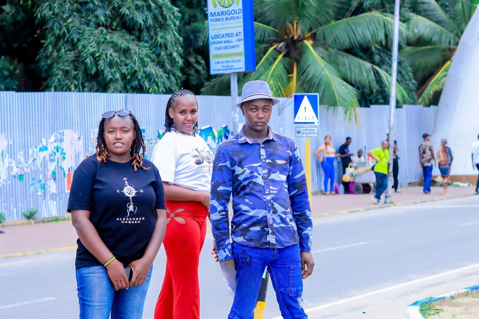 Three guests posing on Moi Avenue near the Mombasa Tusks