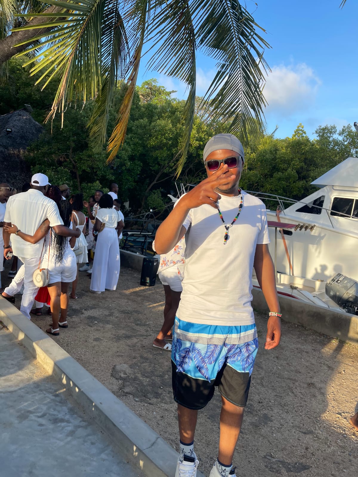 Guest at a white-attire beach sunset gathering in Mombasa