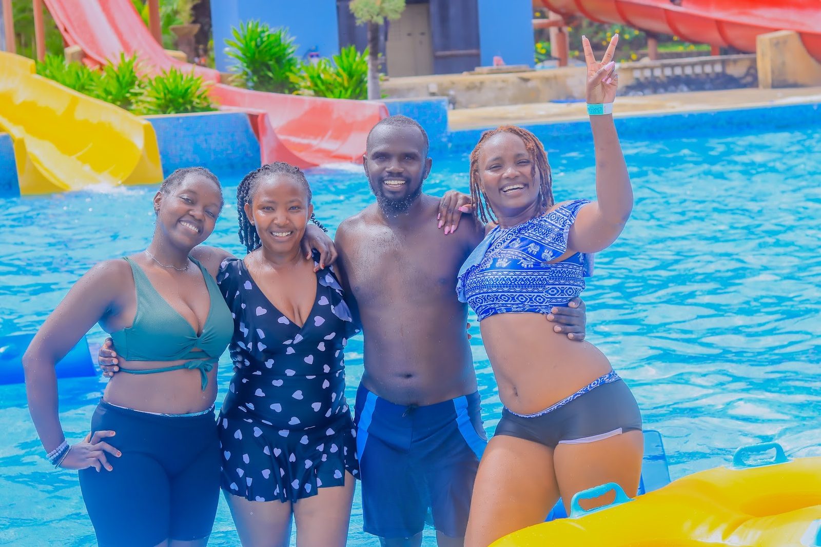 Friends posing in the pool at Wild Waters