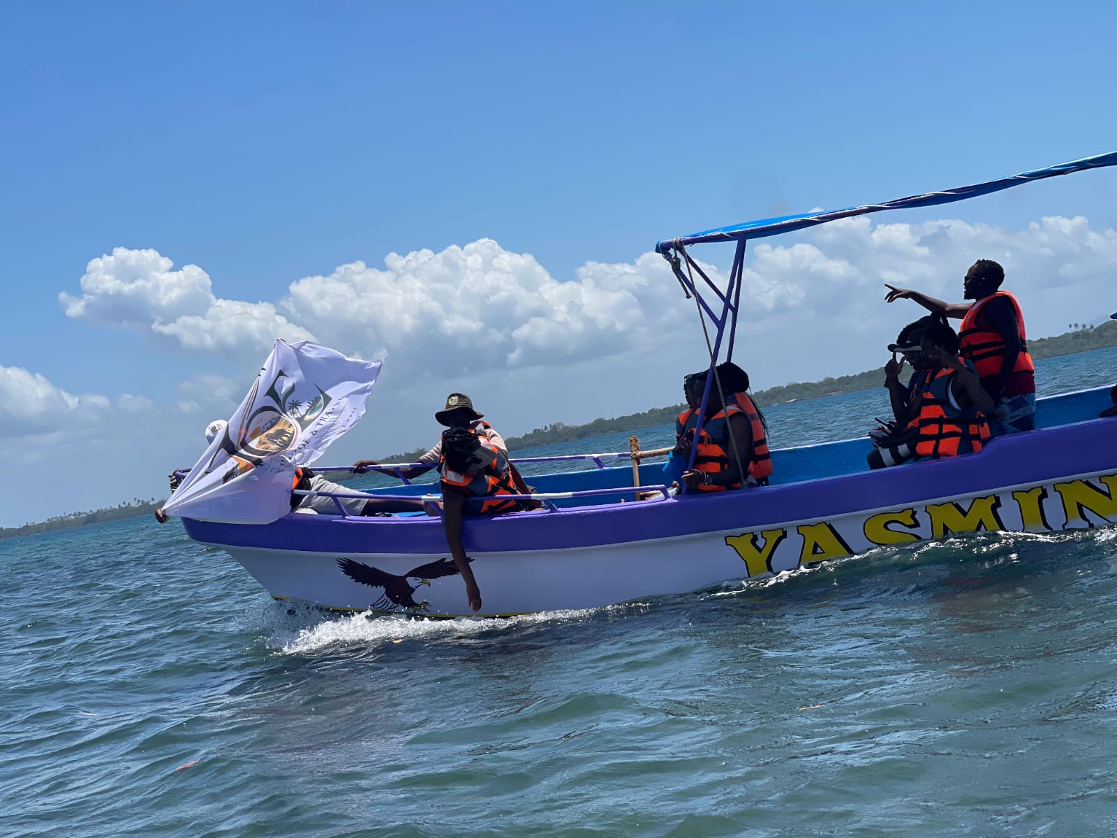 The Yasmin boat underway with guests aboard and the JOE flag flying