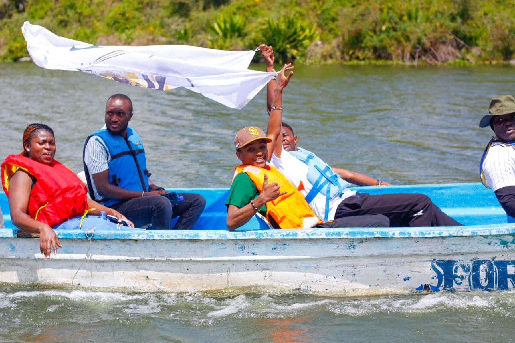 Waving the flag from the boat out on Lake Naivasha